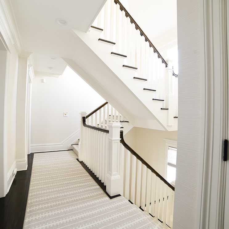 newly painted flight of stairs and hallway